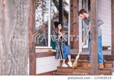 Couple enjoying fall and leisure time outdoors in the private house backyard Couple enjoying fall and leisure time outdoors in the private house backyard 114468619