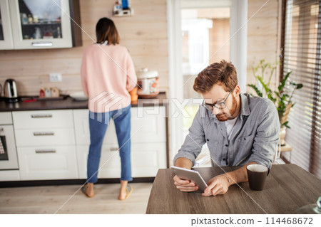 Young couple spending morning in new home, discussing their plans for future 114468672
