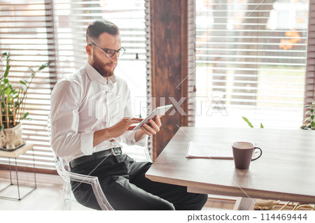Serious applicant sitting in boardroom, preparing for interview with employer. 114469444