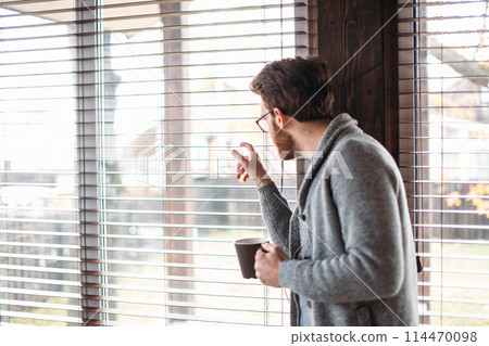 Young couple watching video online in a tablet relaxing home together. Young couple watching video online in a tablet relaxing home together. 114470098