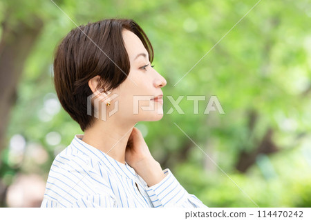 A woman relaxing in the fresh greenery A woman relaxing in the fresh greenery 114470242