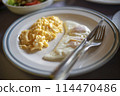 Scrambled eggs and fried egg on the table for breakfast 114470486