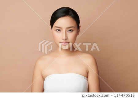 Beautiful young asian woman with clean fresh skin on beige background, Face care, Facial treatment, Cosmetology, beauty and spa, Asian women portrait. 114470512