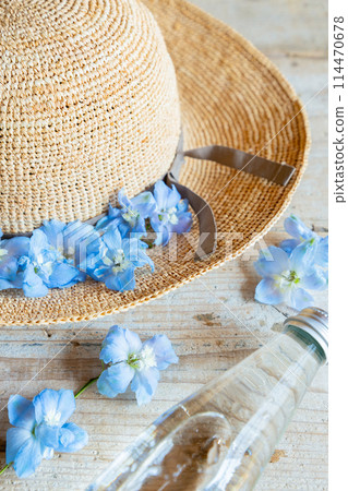 Blue flowers and straw hats that evoke summer Blue flowers and straw hats that evoke summer 114470678