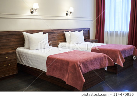 Two single beds with white linens are located in the bedrooms of the hotels, with space to copy. High quality photo Two single beds with white linens are located in the bedrooms of the hotels, with space to copy. High quality photo 114470936