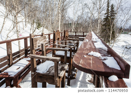 winter cafe, wooden tables and chairs under snow winter cafe, wooden tables and chairs under snow 114470950