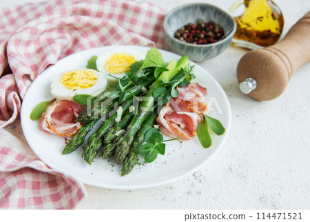 Fresh Asparagus and Prosciutto Salad Served With Boiled Eggs and Microgreens 114471521