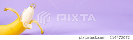 Intimate piercing. Minimal piercing concept. Banana with piercing on purple background 114472072