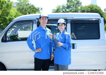 Male and female delivery drivers lined up outdoors Male and female delivery drivers lined up outdoors 114472309