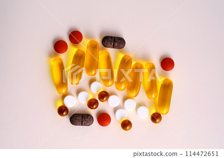 Pills, vitamins and dietary supplements on a beige background. 114472651