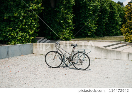 Locked bicycle at bicycle parking. Transport, storage and vehicle concept. Green pergola in Park Locked bicycle at bicycle parking. Transport, storage and vehicle concept. Green pergola in Park 114472942