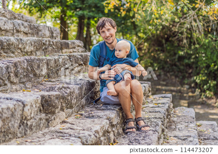 Dad and son tourists at Coba, Mexico. Ancient mayan city in Mexico. Coba is an archaeological area and a famous landmark of Yucatan Peninsula. Cloudy sky over a pyramid in Mexico 114473207