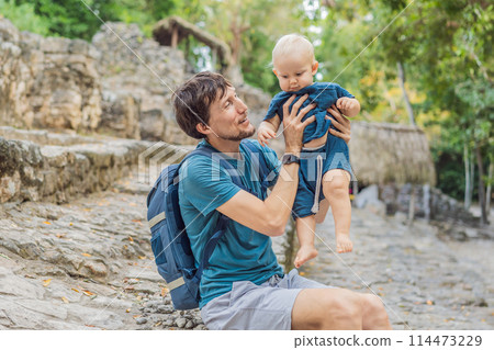 Dad and son tourists at Coba, Mexico. Ancient mayan city in Mexico. Coba is an archaeological area and a famous landmark of Yucatan Peninsula. Cloudy sky over a pyramid in Mexico 114473229