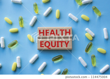 Health Equity symbol. Wooden blocks with words Health Equity. Beautiful blue background with pills. Medicine and Health Equity concept. Copy space. Health Equity symbol. Wooden blocks with words Health Equity. Beautiful blue background with pills. Medicine and Health Equity concept. Copy space. 114475004