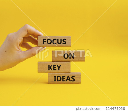 Focus on Key Ideas symbol. Concept words Focus on Key Ideas on wooden blocks. Beautiful yellow background. Businessman hand. Business and Focus on Key Ideas concept. Copy space Focus on Key Ideas symbol. Concept words Focus on Key Ideas on wooden blocks. Beautiful yellow background. Businessman hand. Business and Focus on Key Ideas concept. Copy space 114475038