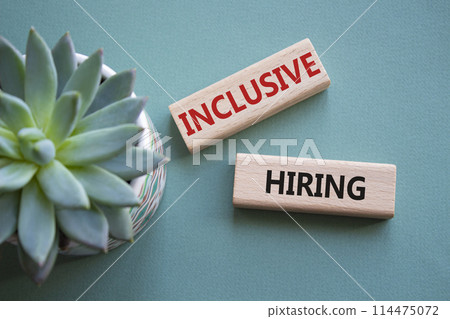 Inclusive Hiring symbol. Wooden blocks with words Inclusive Hiring. Businessman hand. Beautiful grey green background with succulent plant. Business and Inclusive Hiring concept. Copy space. Inclusive Hiring symbol. Wooden blocks with words Inclusive Hiring. Businessman hand. Beautiful grey green background with succulent plant. Business and Inclusive Hiring concept. Copy space. 114475072