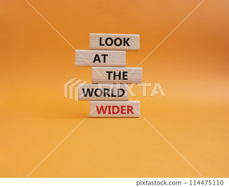 Look at the world wider symbol. Wooden blocks with words Look at the world wider. Beautiful orange background. Business and Look at the world wider concept. Copy space. 114475110