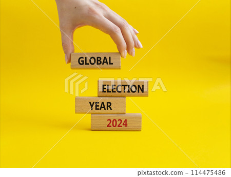 Global Election year 2024 symbol. Concept words Global Election year 2024 on wooden blocks. Beautiful yellow background. Businessman hand. Business and Global Election year 2024 concept. Copy space Global Election year 2024 symbol. Concept words Global Election year 2024 on wooden blocks. Beautiful yellow background. Businessman hand. Business and Global Election year 2024 concept. Copy space 114475486