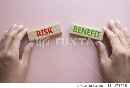 Risk or Benefit symbol. Concept word Risk or Benefit on wooden blocks. Businessman hand. Beautiful pink background. Business and Risk or Benefit concept. Copy space Risk or Benefit symbol. Concept word Risk or Benefit on wooden blocks. Businessman hand. Beautiful pink background. Business and Risk or Benefit concept. Copy space 114475736