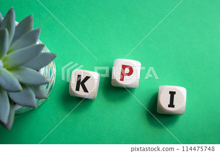 KPI- Key Performance Indicator. Wooden cubes with word KPI. Beautiful green background with succulent plant. Business and Key Performance Indicator concept. Copy space. 114475748