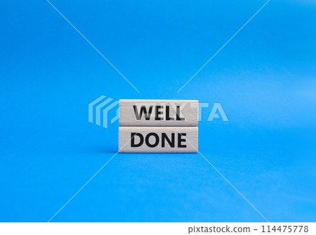 Well done symbol. Wooden blocks with words Well done. Beautiful blue background. Business and Well done concept. Copy space. 114475778