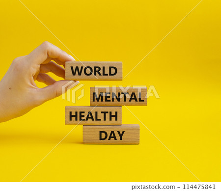 World Mental Health Day symbol. Wooden blocks with words World Mental Health Day. Businessman hand. Beautiful yellow background. Health concept. Copy space. World Mental Health Day symbol. Wooden blocks with words World Mental Health Day. Businessman hand. Beautiful yellow background. Health concept. Copy space. 114475841