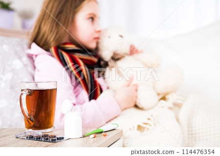 Medcine with tea for little ill girl with bear Medcine with tea for little ill girl with bear 114476354