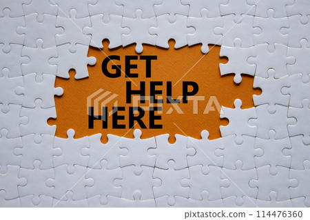 Get help here symbol. White puzzle with words Get help here. Beautiful orange background. Business and Get help here concept. Copy space. Get help here symbol. White puzzle with words Get help here. Beautiful orange background. Business and Get help here concept. Copy space. 114476360