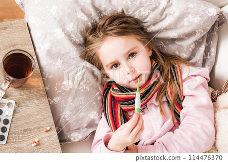 Little ill girl measuring temperature 114476370