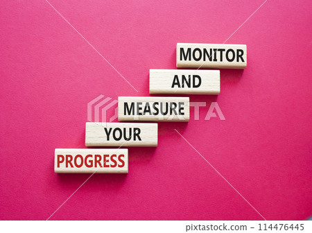 Monitor and Measure your Progress symbol. Wooden blocks with words Monitor and Measure your Progress. Beautiful red background. Business and Monitor and Measure your Progress concept. Copy space 114476445