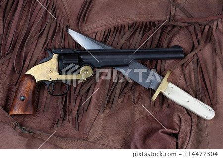 Old West Revolver with bowie knife on leather jacket Old West Revolver with bowie knife on leather jacket 114477304