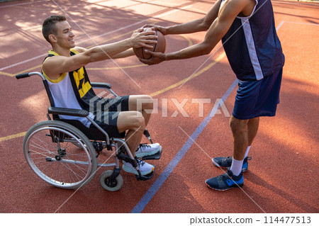 Basketball player with disability training on basketball court Basketball player with disability training on basketball court 114477513