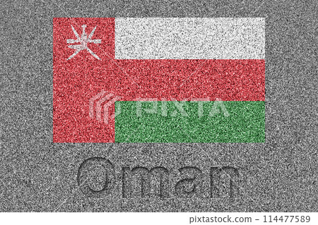 The Omani flag painted on a stone slab with the word "Oman" carved into it 114477589