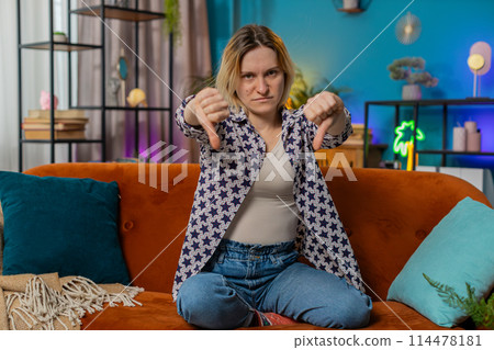 Woman showing thumbs down sign gesture expressing discontent disapproval dissatisfied feedback Woman showing thumbs down sign gesture expressing discontent disapproval dissatisfied feedback 114478181