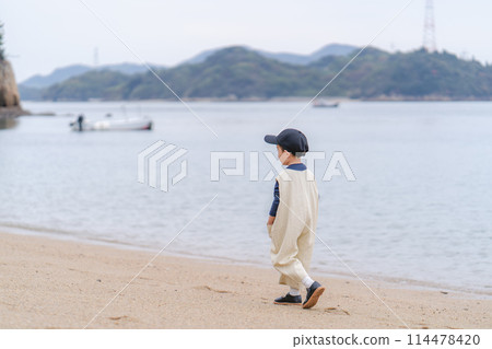 Child boy with the sea in the background Child boy with the sea in the background 114478420