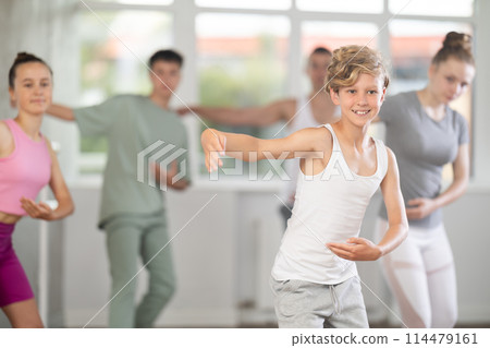 Teenage boy practicing ballet positions in dance studio 114479161