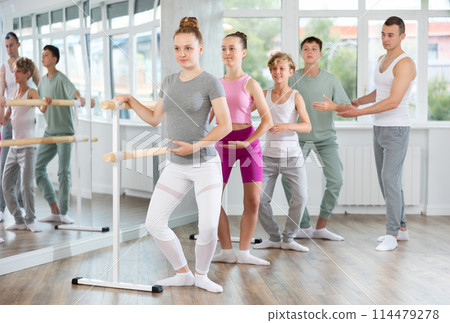 Teenage girl practicing plie position of ballet during choreography classes Teenage girl practicing plie position of ballet during choreography classes 114479278