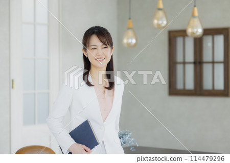 Woman in a white suit Woman in a white suit 114479296