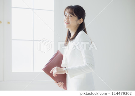 Woman in a white suit 114479302