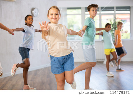 Preteen children learning to dance waltz in pairs in choreography class Preteen children learning to dance waltz in pairs in choreography class 114479371