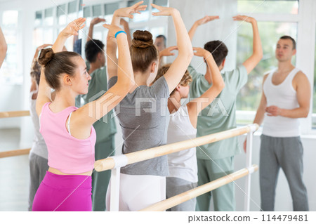 Teenage girl practicing ballet positions in dance studio 114479481