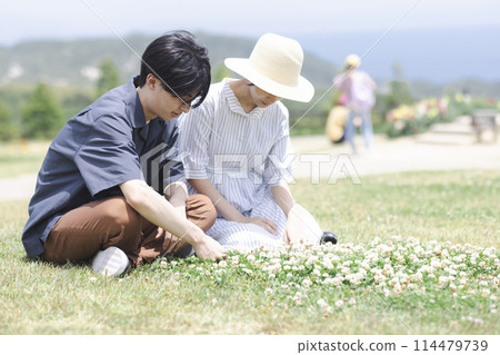Young men and women relaxing on the grass 114479739
