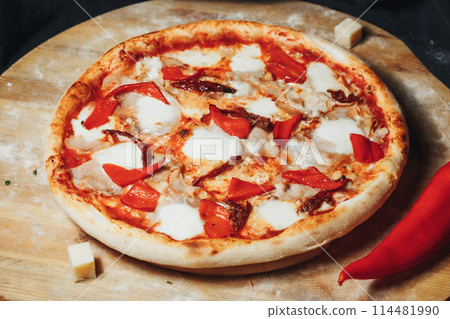 Fiery Pepper Pizza on Rustic Cutting Board Fiery Pepper Pizza on Rustic Cutting Board 114481990