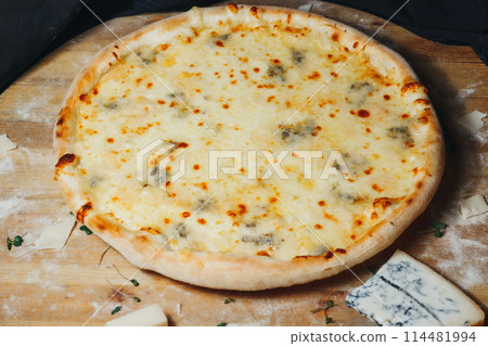 Melting Mozzarella: A Delicious Pizza on Wooden Board 114481994
