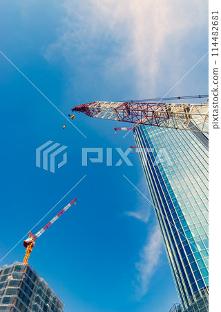 Building construction and cranes stretching into the blue sky Takanawa Gateway 2024.04 d-4 Warm colors added Building construction and cranes stretching into the blue sky Takanawa Gateway 2024.04 d-4 Warm colors added 114482681