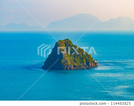 Aerial drone top view photo of small exotic atoll island. Top view of a small green island in the blue sea, ocean.  114483825