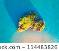 Aerial drone top view photo of small exotic atoll island. Top view of a small green island in the blue sea, ocean.  114483826