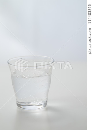 Glass of carbonated water by the window Glass of carbonated water by the window 114483866