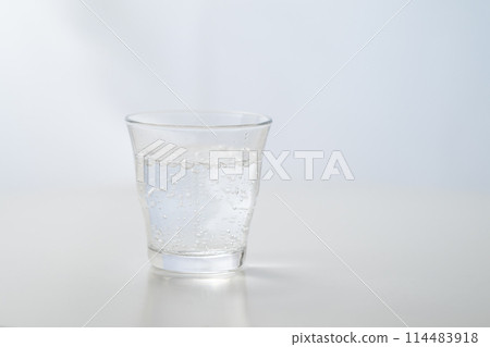 Glass of carbonated water by the window Glass of carbonated water by the window 114483918