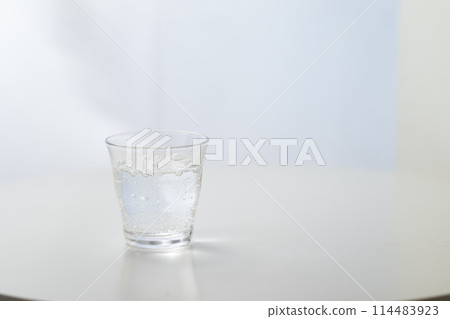 Glass of carbonated water by the window Glass of carbonated water by the window 114483923